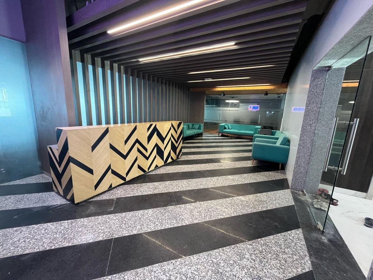 Reception counter and lounge with patterned flooring
